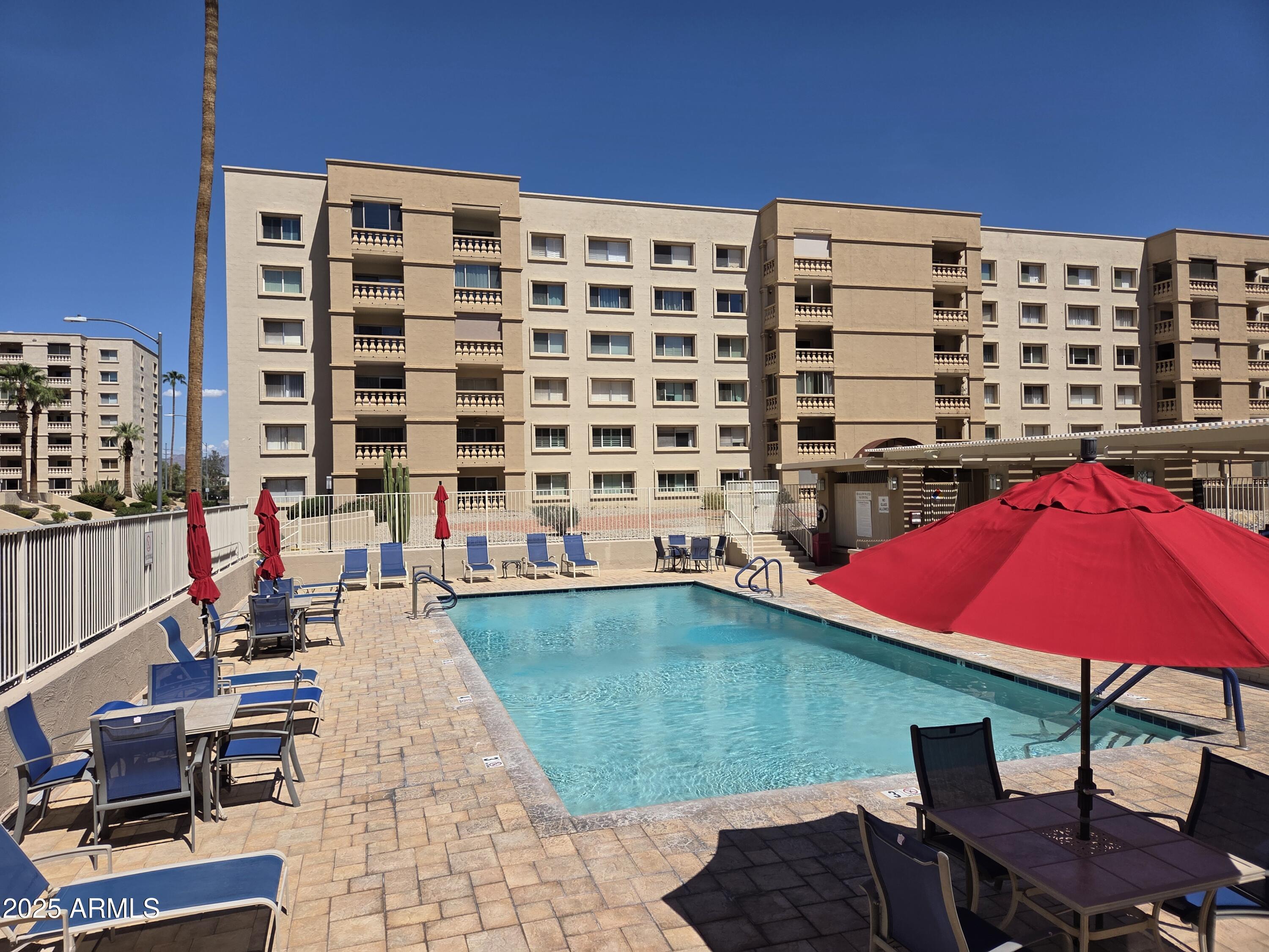 7920 East Camelback Road, Unit 408 Scottsdale, AZ 85251 - Photo 18 of 18 a view of a swimming pool with chairs