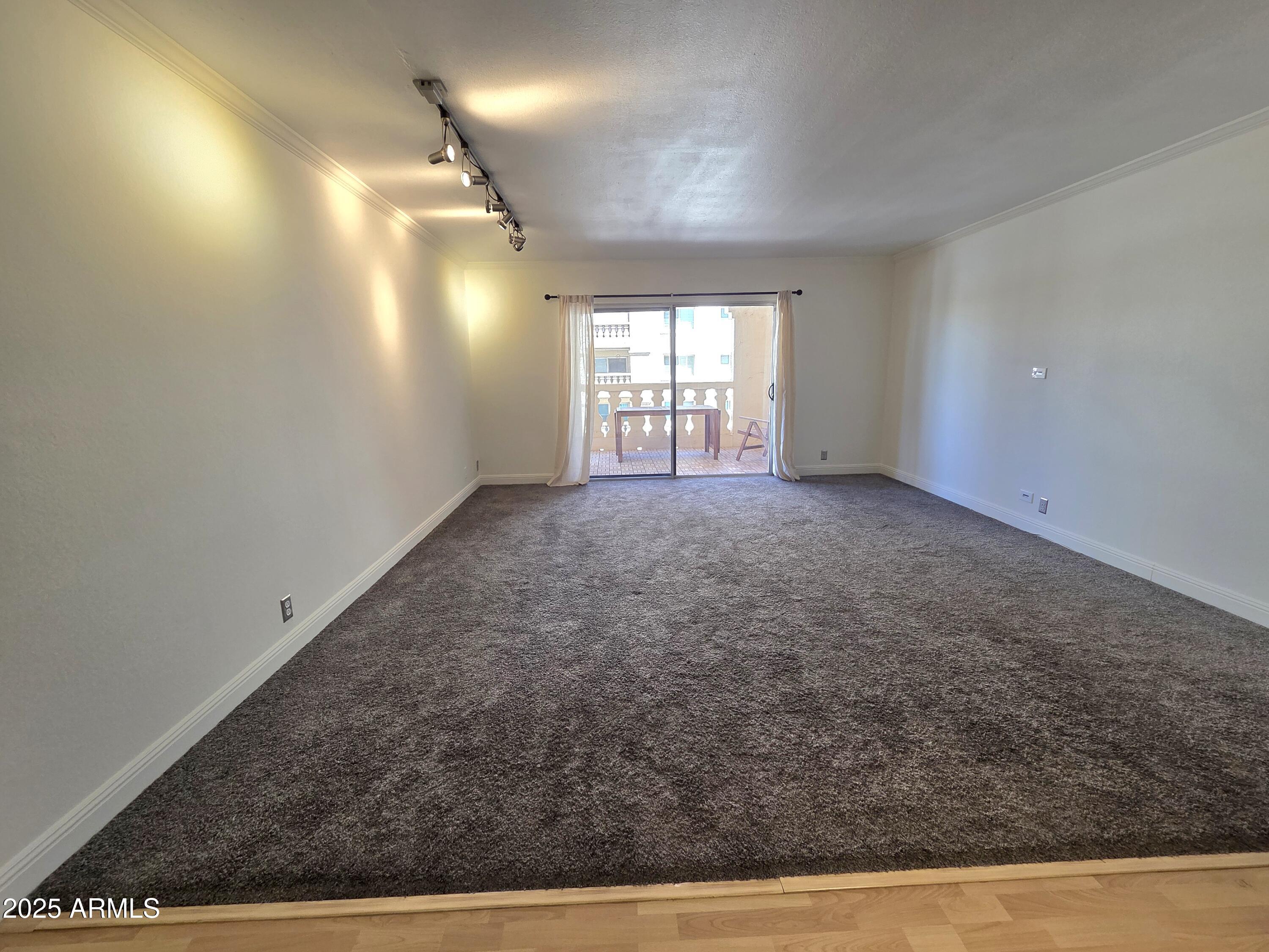 7920 East Camelback Road, Unit 408 Scottsdale, AZ 85251 - Photo 2 of 18 a view of empty room with wooden floor