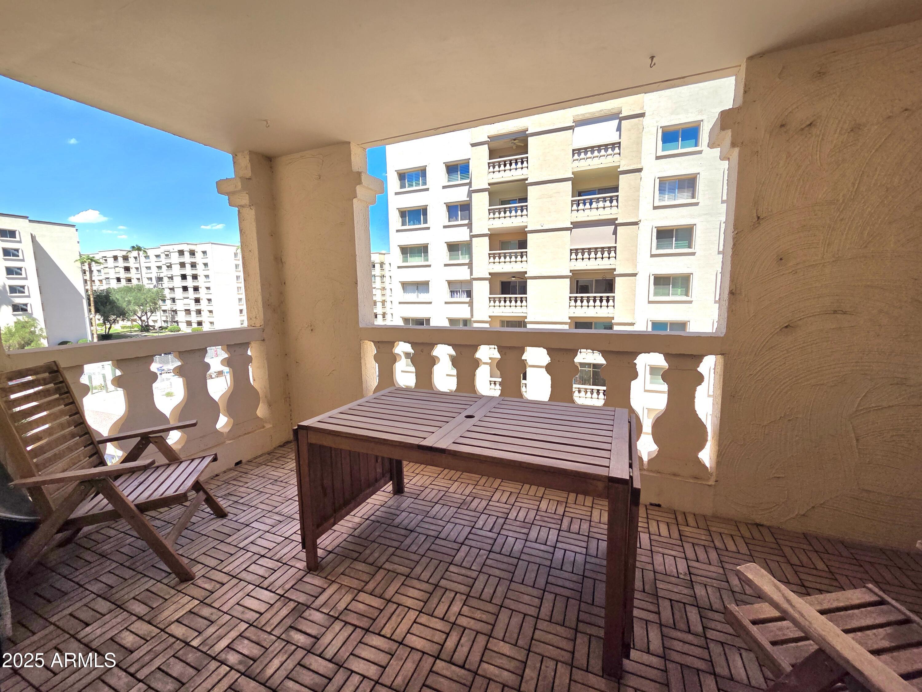 7920 East Camelback Road, Unit 408 Scottsdale, AZ 85251 - Photo 5 of 18 a wooden bench sitting in front of a window