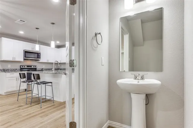 a bathroom with a sink a mirror and a shower