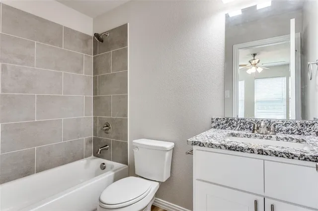 a bathroom with a sink toilet vanity and bathtub