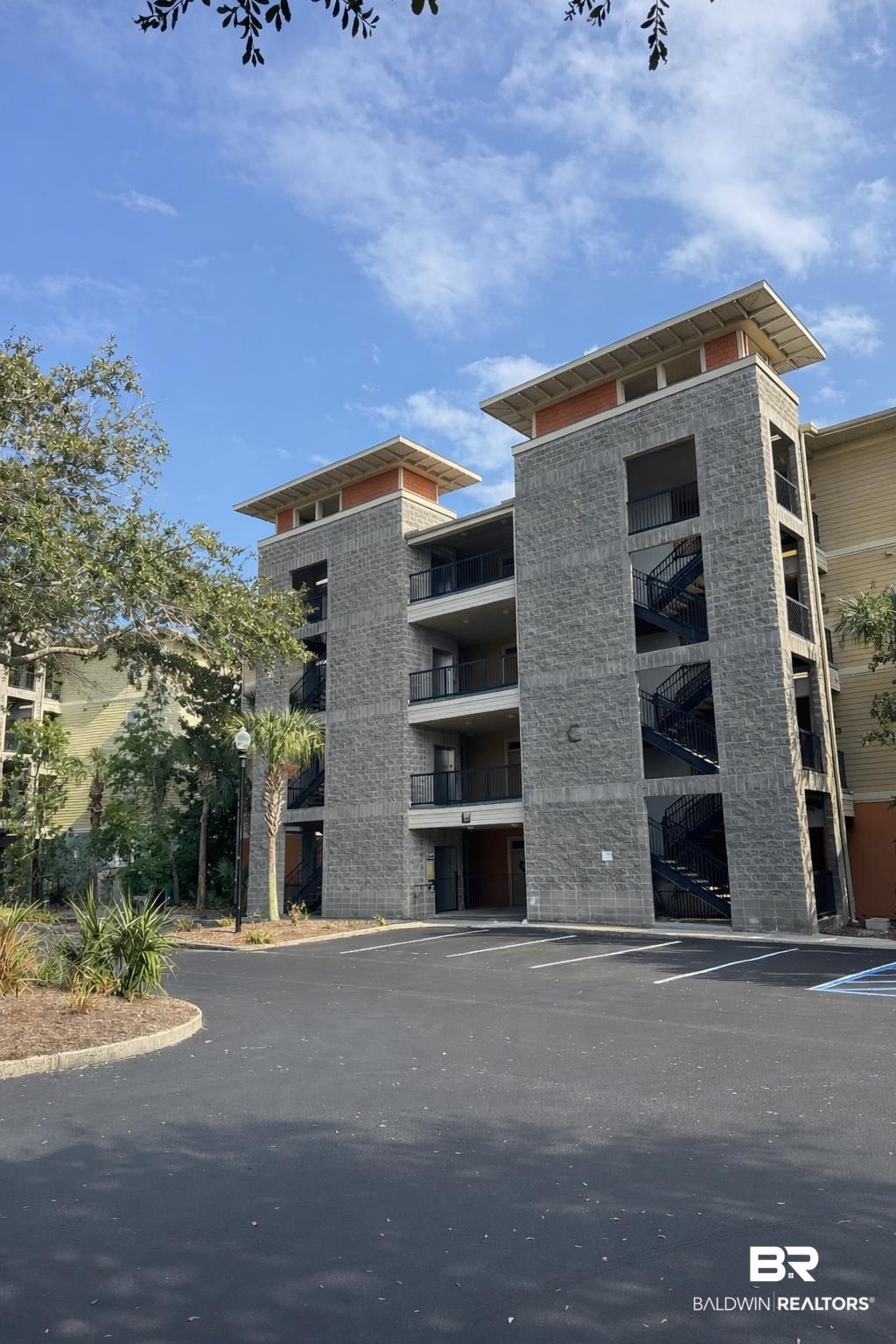 1430 Regency Road, Unit C101 Gulf Shores, AL 36542 - Photo 1 of 32 View of apartment building / complex with uncovered parking
