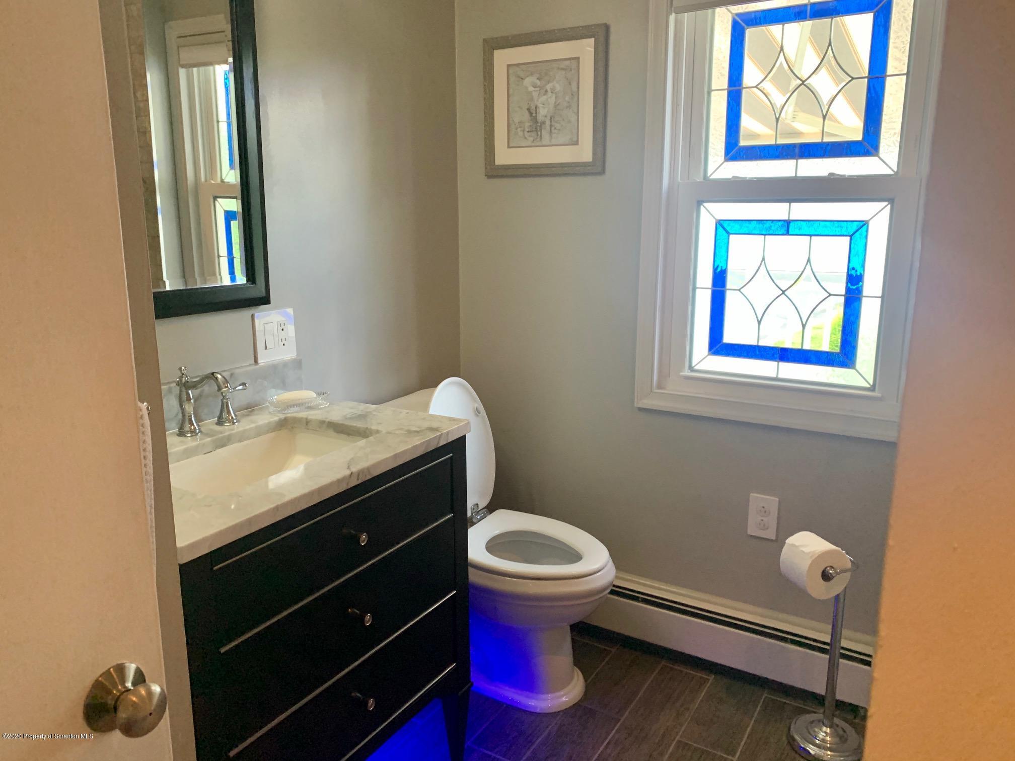 1094 Rutter Avenue Kingston, PA 18704 - Photo 14 of 35 a bathroom with a granite countertop toilet sink and mirror