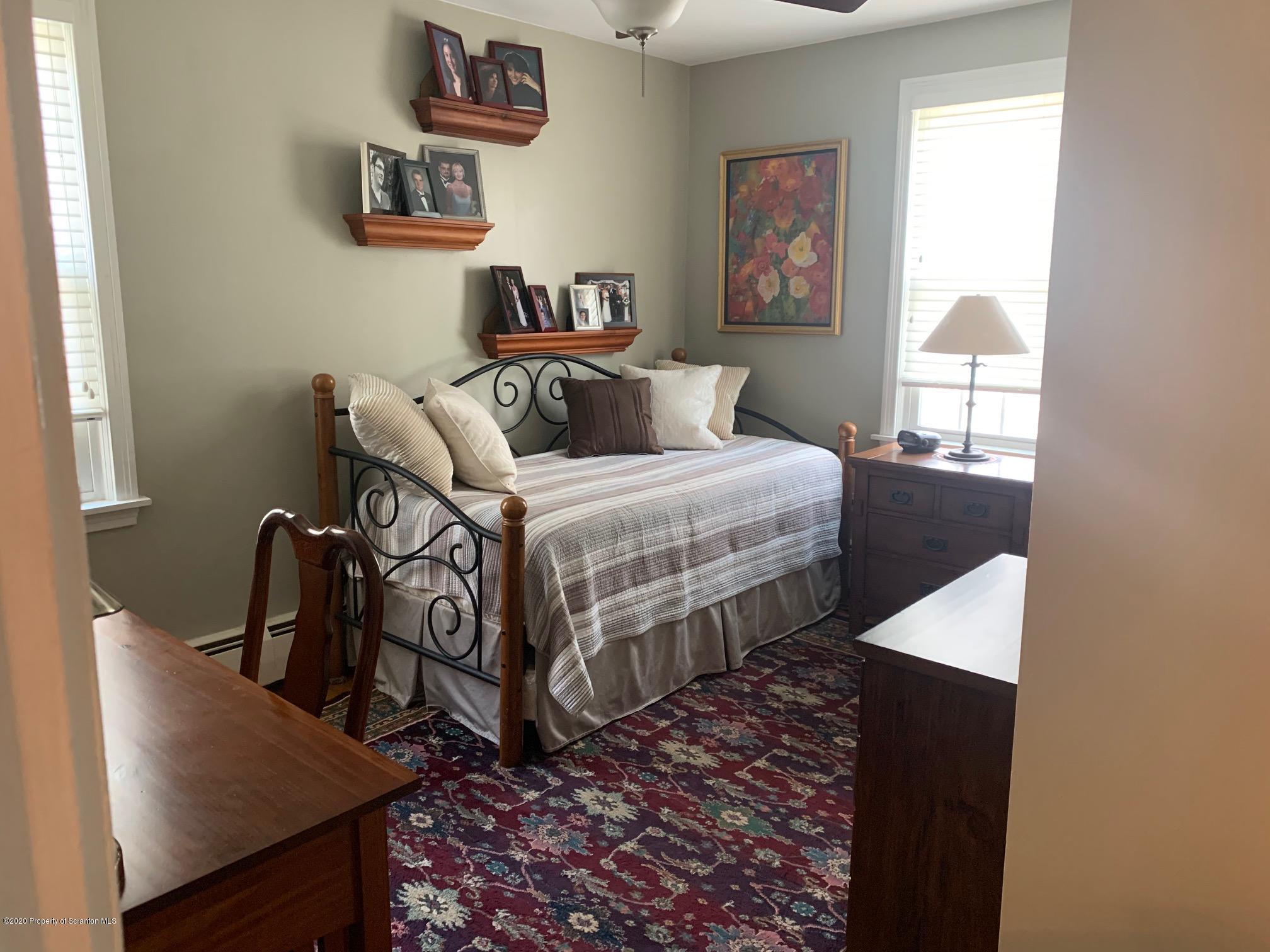 1094 Rutter Avenue Kingston, PA 18704 - Photo 16 of 35 a bedroom with bed and wooden floor