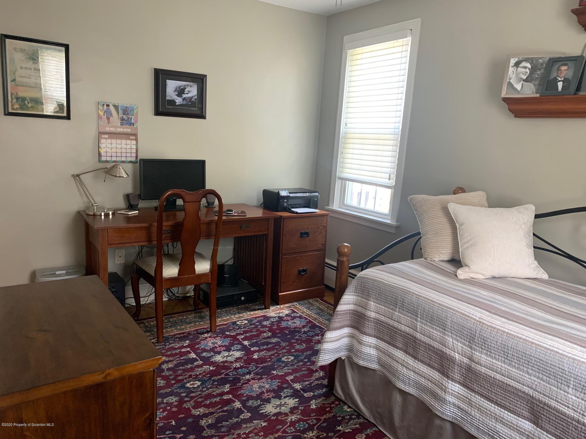 1094 Rutter Avenue Kingston, PA 18704 - Photo 17 of 35 a bed room with a bed and a chair