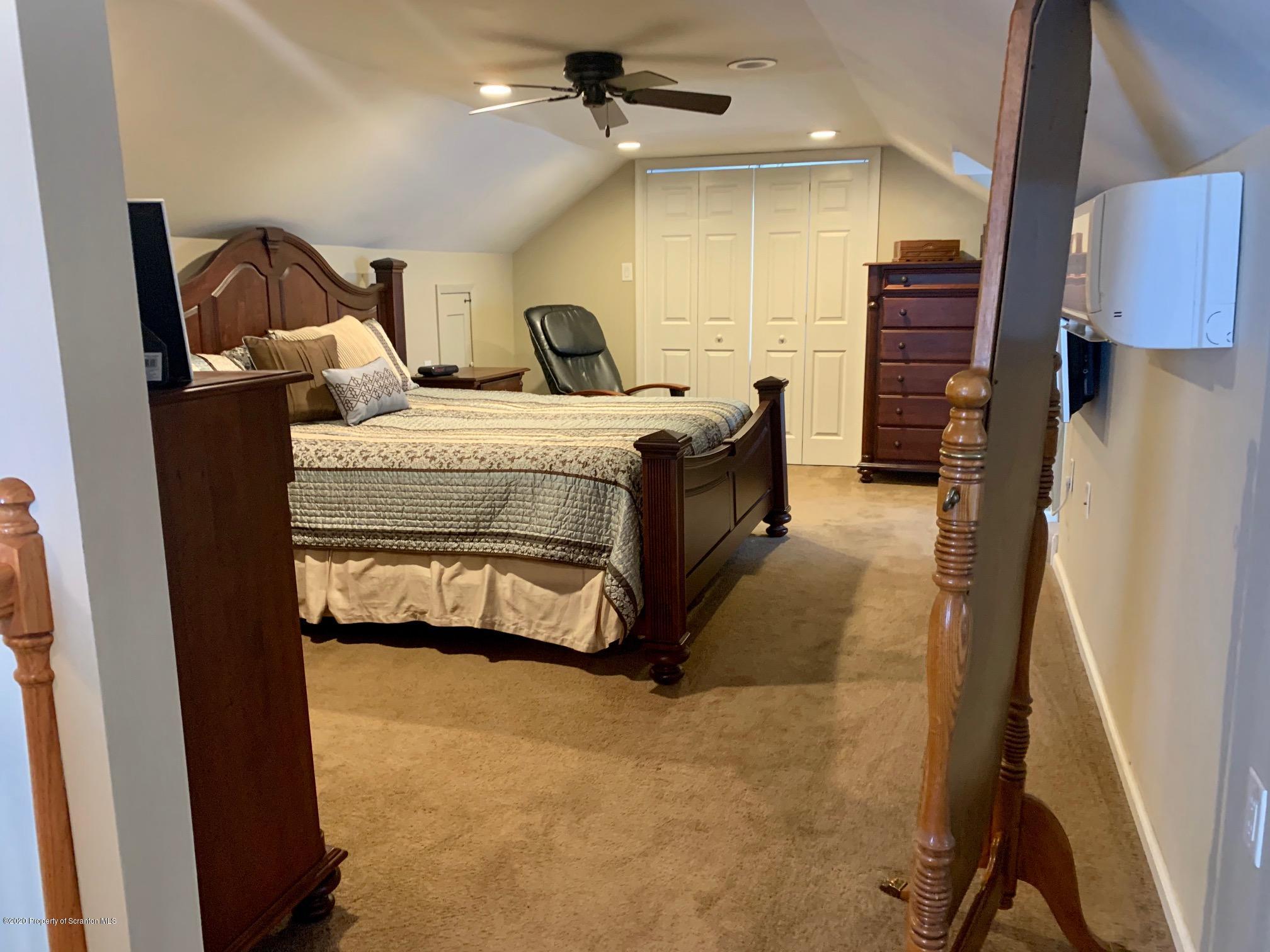 1094 Rutter Avenue Kingston, PA 18704 - Photo 18 of 35 a spacious bedroom with a bed and a couch