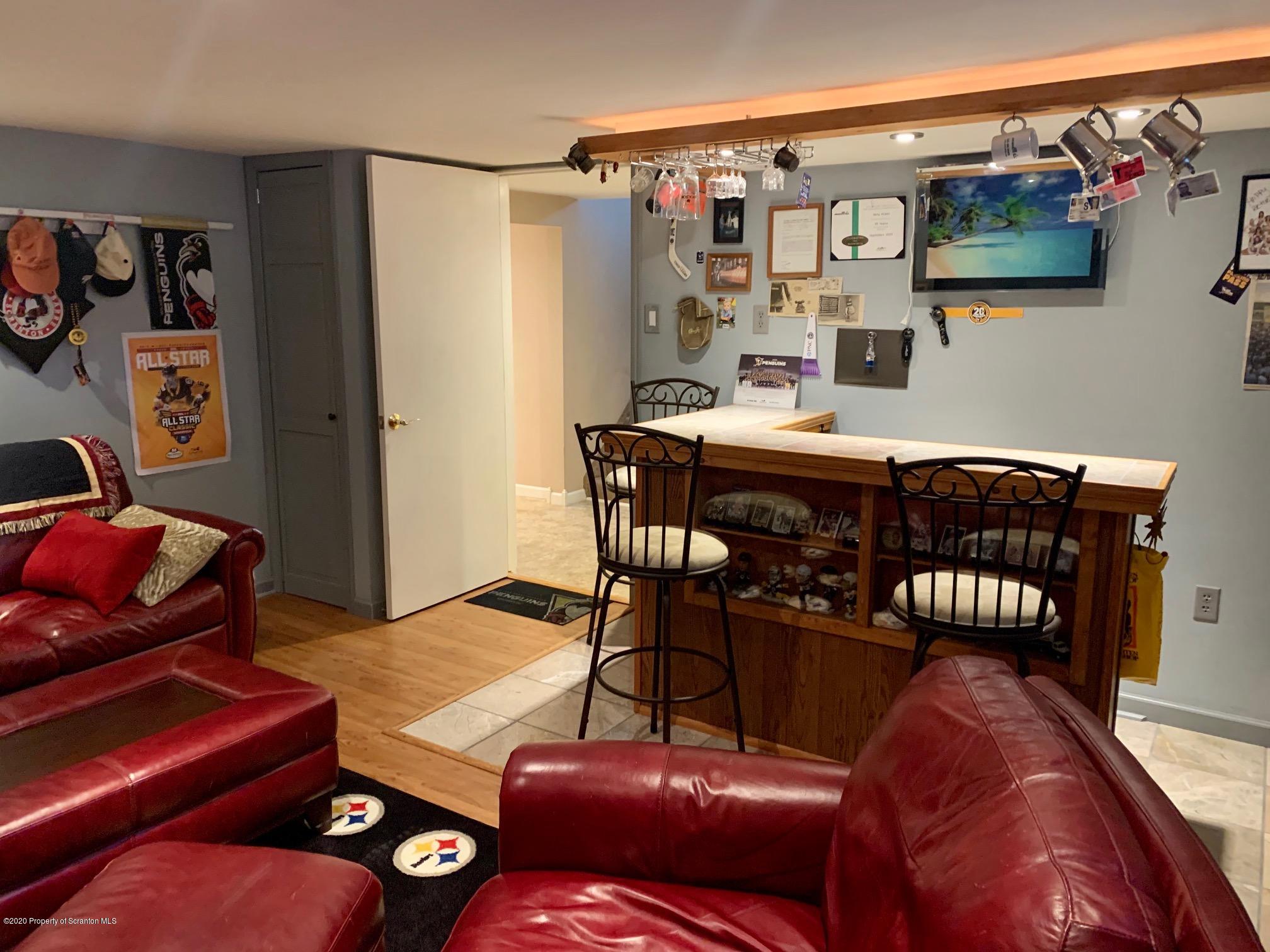 1094 Rutter Avenue Kingston, PA 18704 - Photo 25 of 35 a living room with furniture a flat screen tv and a couch