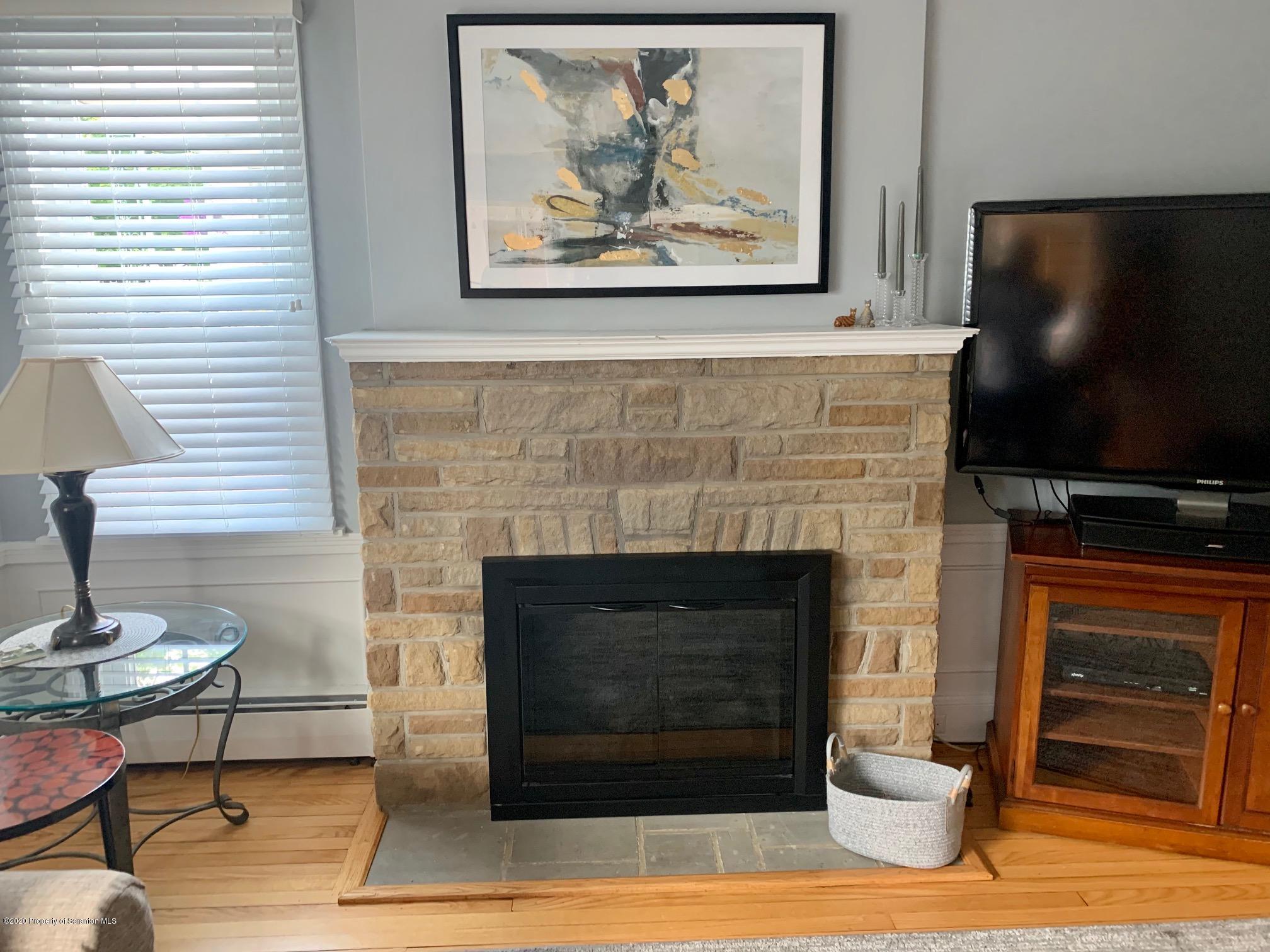 1094 Rutter Avenue Kingston, PA 18704 - Photo 5 of 35 a living room with a fireplace and a flat screen tv