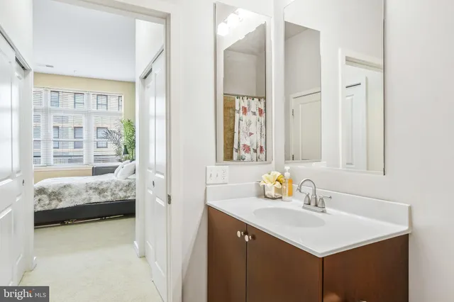 a en suite bathroom with sink and mirror