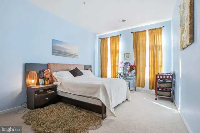 a bedroom with a bed and a tv