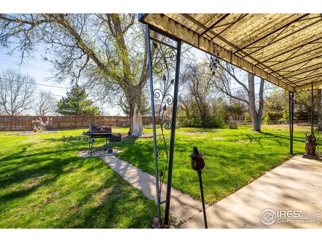 a view of yard with swimming pool and green space