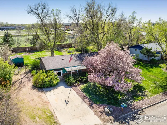 a view of house with garden space and trees