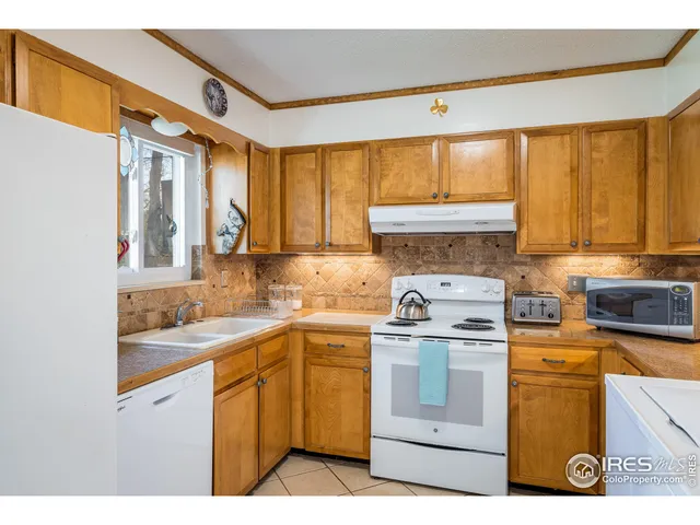 a living room with furniture a large window and a chandelier