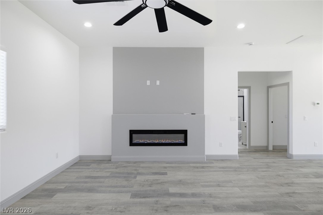 1061 Factory Road Pahrump, NV 89048 - Photo 8 of 41 A chic living area with a contemporary fireplace and durable wood flooring.