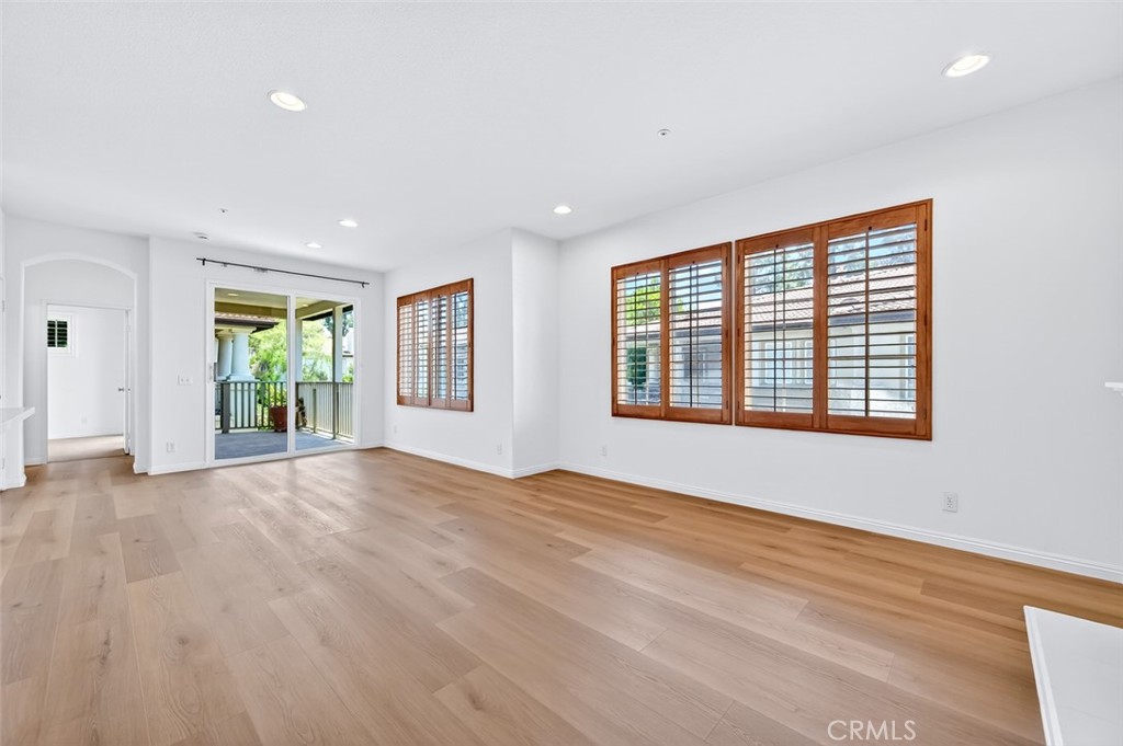 447 Ridgeway Irvine, CA 92620 - Photo 51 of 88 a view of an empty room with wooden floor and windows