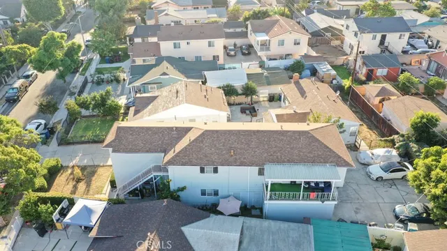 an aerial view of a house with garden space and street view