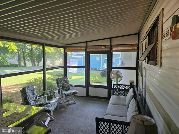 a living room with furniture and floor to ceiling window