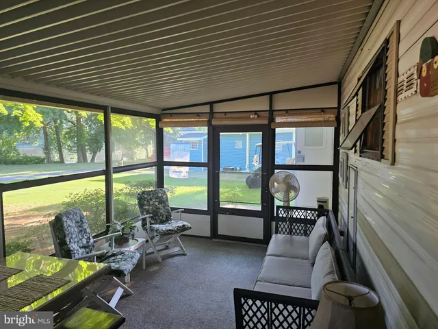 a living room with furniture and floor to ceiling window