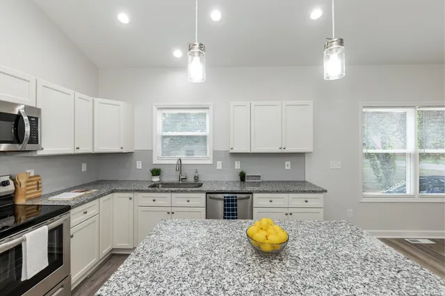 a kitchen with a sink cabinets and window