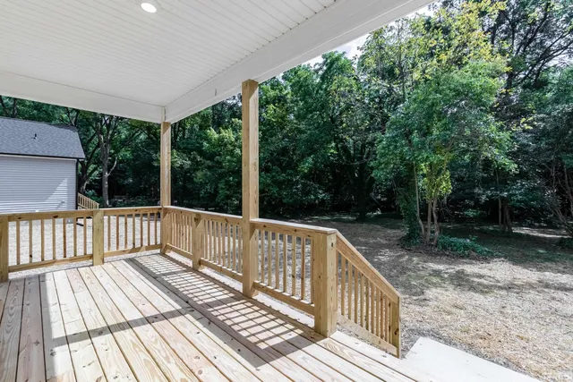 a view of balcony with deck and trees
