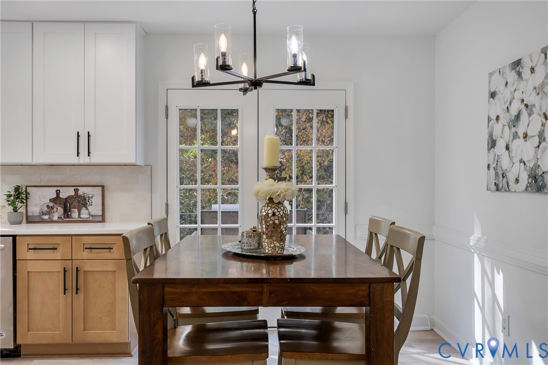 9099 Mossy Brook Road Mechanicsville, VA 23116 - Photo 12 of 29 a view of a dining room with furniture and chandelier