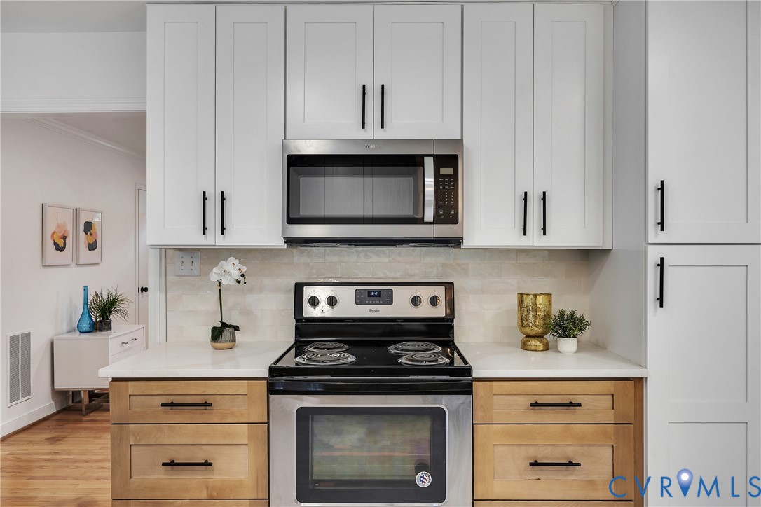 9099 Mossy Brook Road Mechanicsville, VA 23116 - Photo 13 of 29 a kitchen with stainless steel appliances granite countertop white cabinets and a stove a oven with white countertops