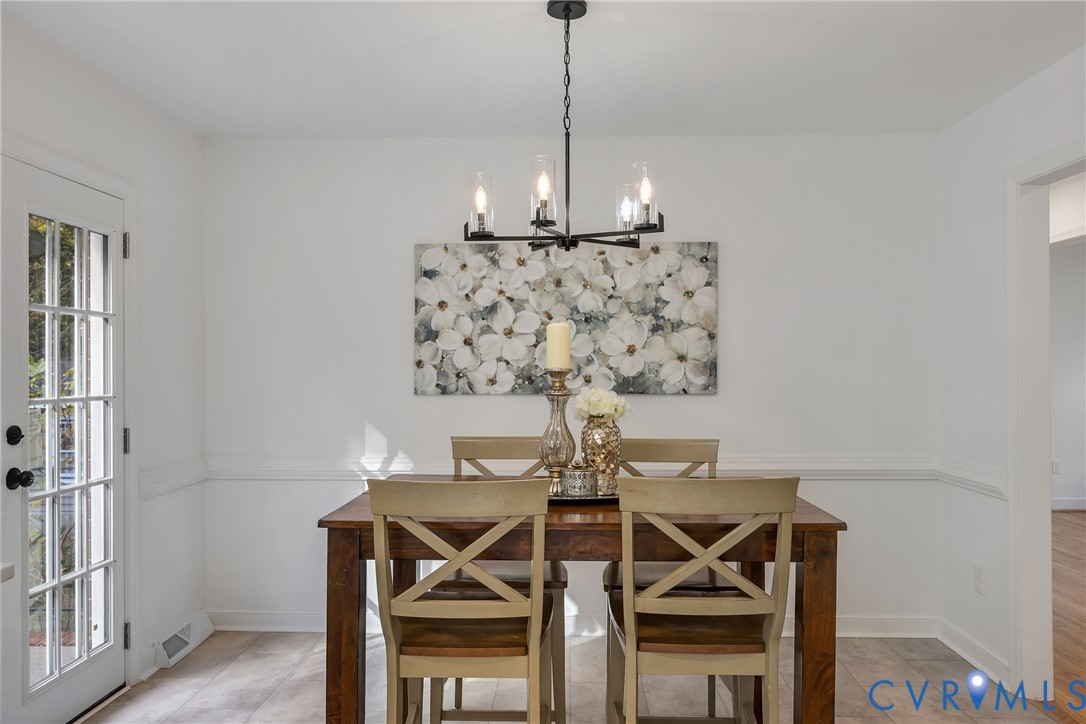 9099 Mossy Brook Road Mechanicsville, VA 23116 - Photo 17 of 29 a view of a dining room with furniture and wooden floor