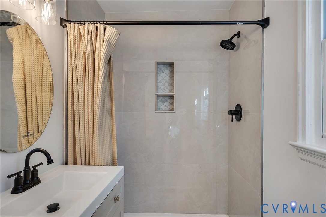 9099 Mossy Brook Road Mechanicsville, VA 23116 - Photo 22 of 29 a bathroom with a sink and mirror