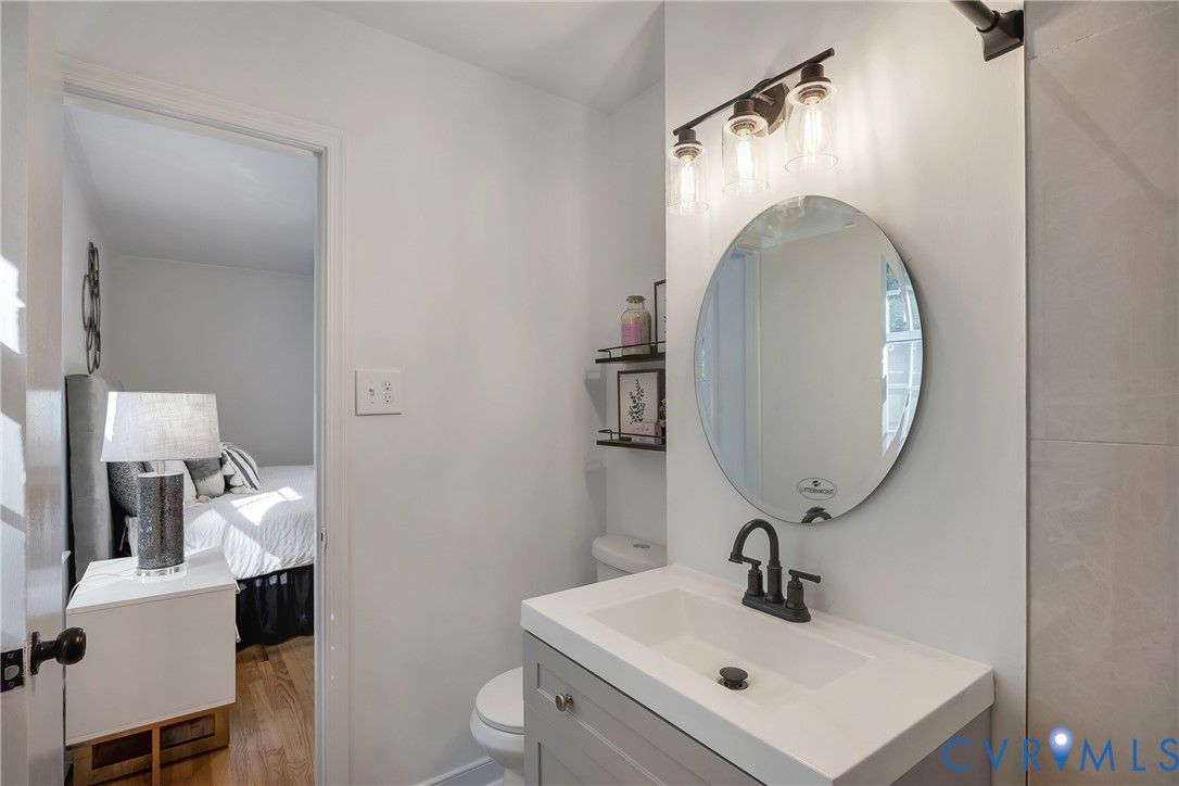 9099 Mossy Brook Road Mechanicsville, VA 23116 - Photo 23 of 29 a bathroom with a sink mirror and toilet