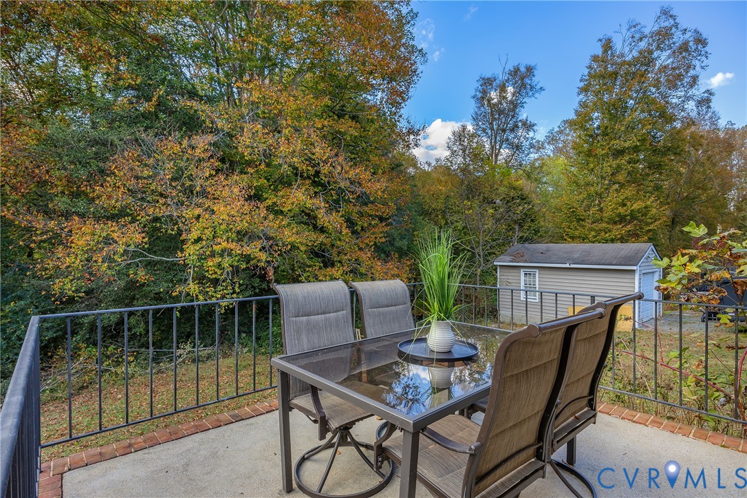 9099 Mossy Brook Road Mechanicsville, VA 23116 - Photo 26 of 29 a backyard of a house with table and chairs