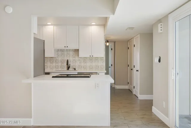 a large kitchen with a lot of white cabinets