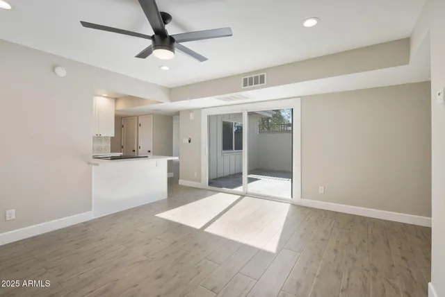 a view of a kitchen with a sink and a refrigerator