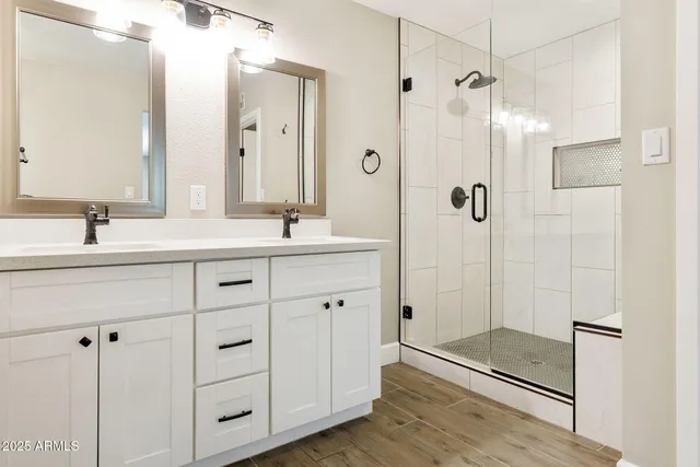 a bathroom with a shower sink and mirror