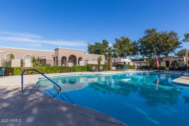 a view of swimming pool with outdoor seating and yard