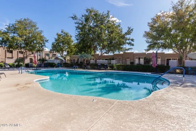 a view of a swimming pool with a yard