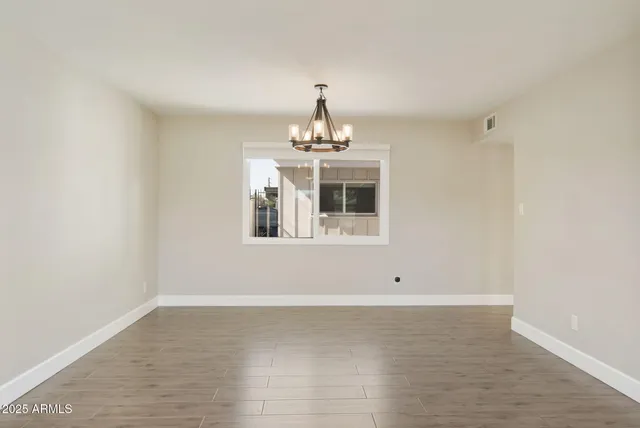 a very nice looking room with a chandelier fan