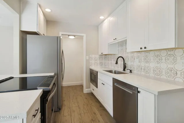 a kitchen with a sink and a refrigerator