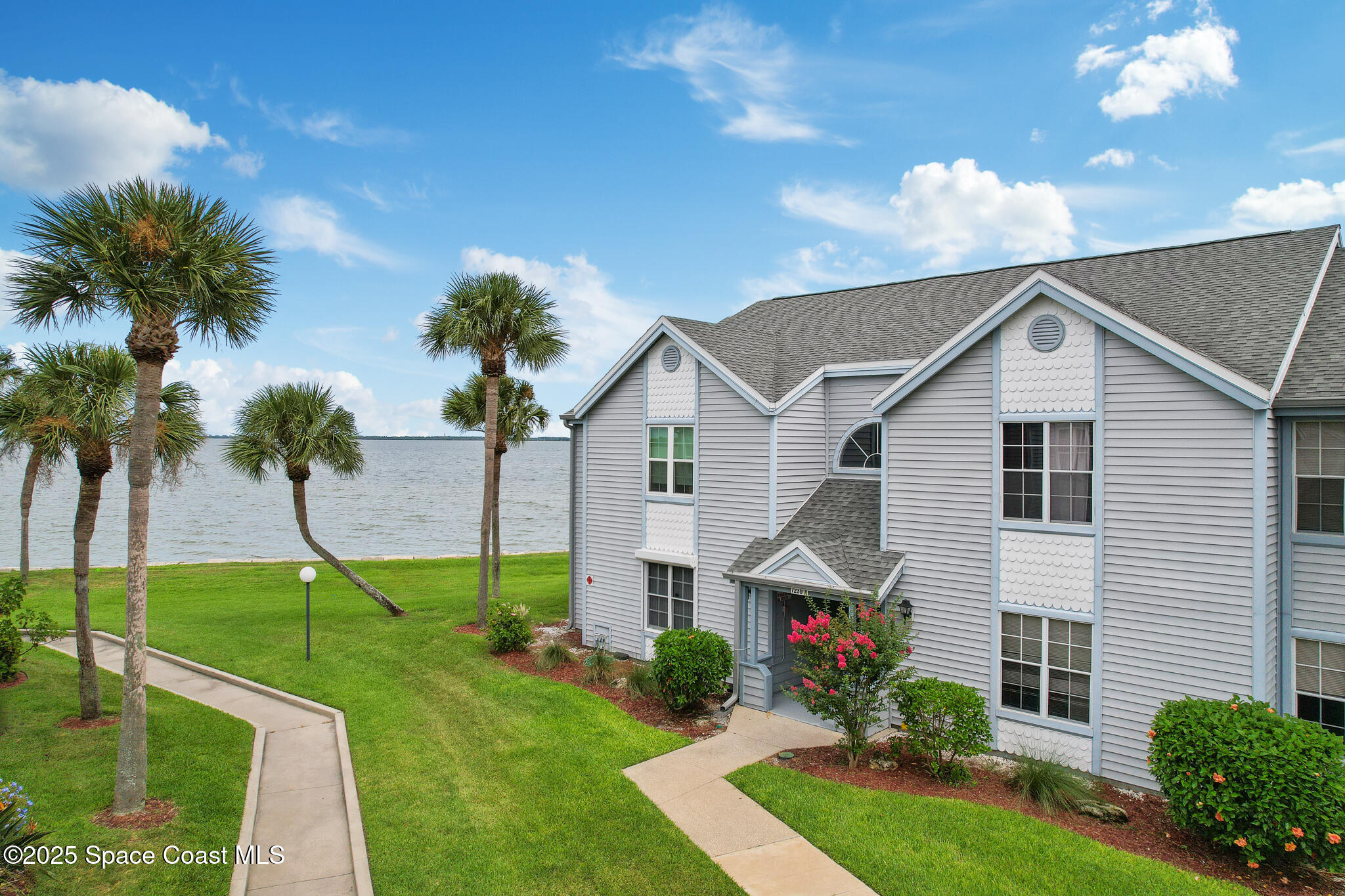7230 N Highway, Unit 202 Cocoa, FL 32922 - Photo 1 of 19 a view of house with a yard and potted plants