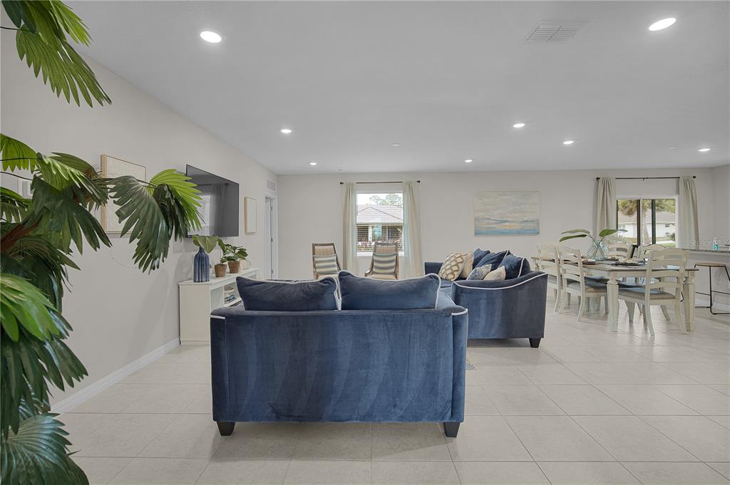418 Fleming Street Sebastian, FL 32958 - Photo 12 of 38 a living room with furniture and a dining table with a potted plant