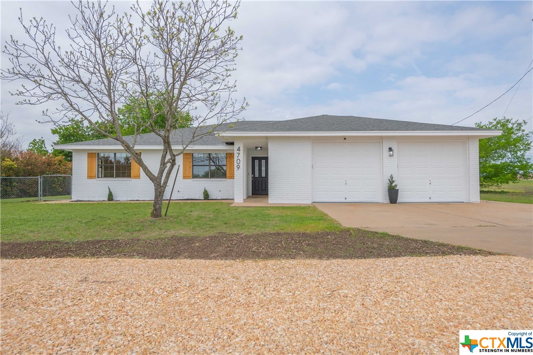a view of a house with a yard and garage