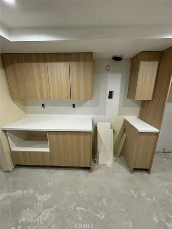 a large kitchen with a large counter top sink and stainless steel appliances