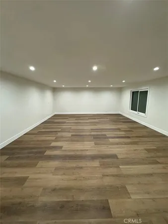 a view of a room with an empty space and a window
