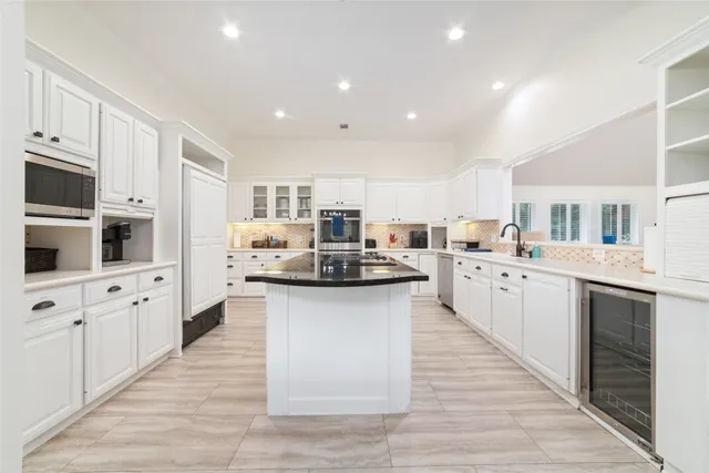 a large kitchen with stainless steel appliances lots of counter space sink and cabinets