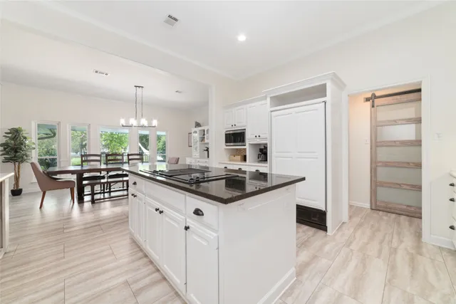 a kitchen with stainless steel appliances granite countertop a stove and a refrigerator