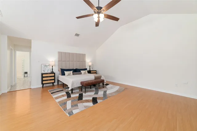a living room with furniture and a dining table