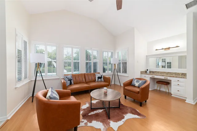 a living room with furniture and a floor to ceiling window