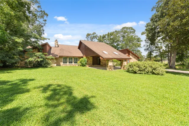 a front view of house with yard and trees