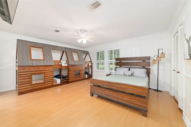 a spacious bedroom with a bed and a chandelier