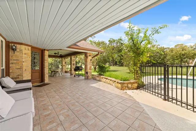 a view of a porch with furniture and garden