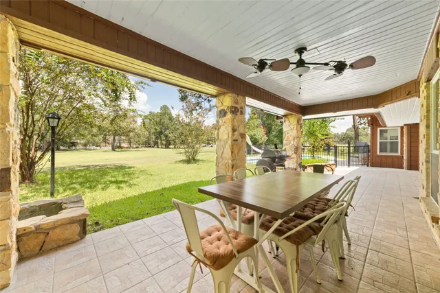 a patio with a table and chairs